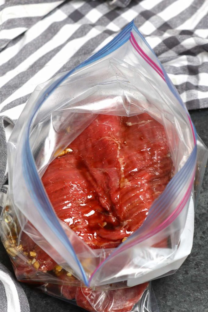 Filete y la marinada en una bolsa zip-top.